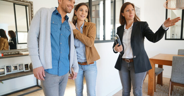 Couple with real-estate agent visiting house for sale